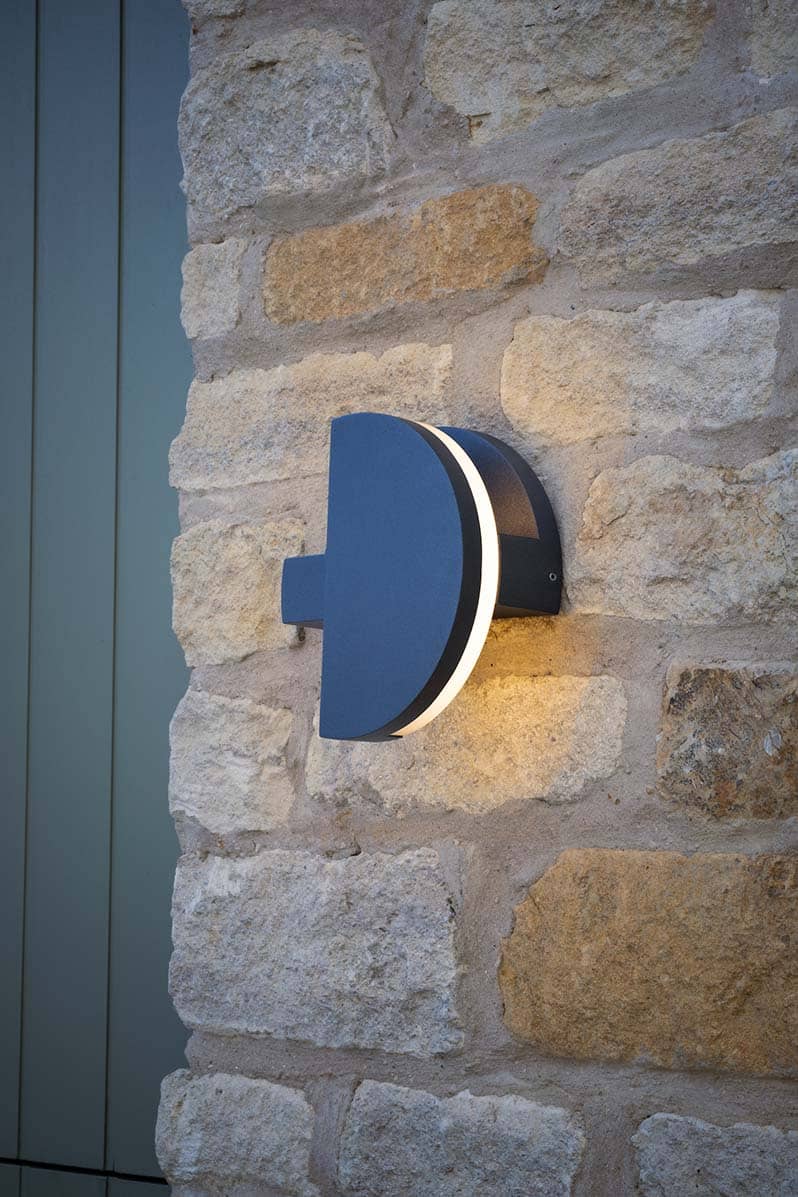 Adjustable Adyson wall light on stone house wall
