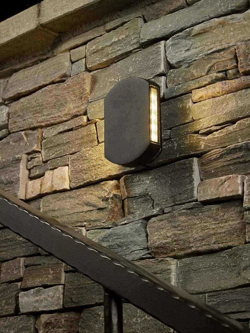 Vulcan wall light on slate stone house wall above staircase